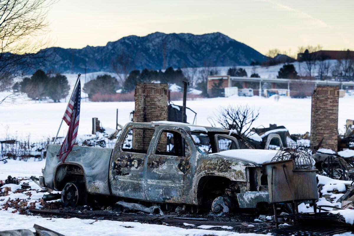 An American flag sits on a burned truck in a neighborhood decimated by the Marshall Fire in Louisville, Colorado, on Jan. 2, 2022. (Michael Ciaglo/Getty Images)