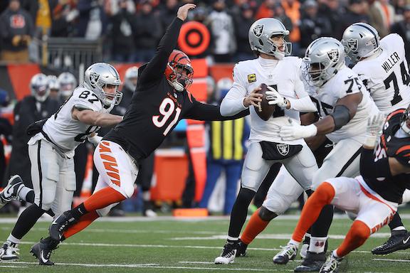 Defensive end Trey Hendrickson #91 of the Cincinnati Bengals forces a fumble on quarterback Derek Carr #4 of the Las Vegas Raiders in the first half of the AFC Wild Card playoff game at Paul Brown Stadium, in Cincinnati, on Jan. 15, 2022. (Dylan Buell/Getty Images)