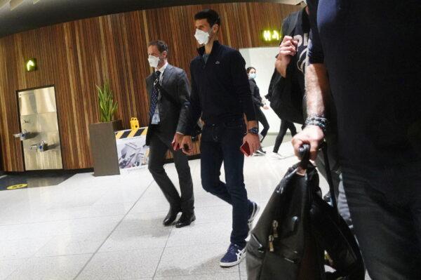 Serbian tennis player Novak Djokovic walks in Melbourne Airport before boarding a flight, after the Federal Court upheld a government decision to cancel his visa to play in the Australian Open, in Melbourne, Australia, on Jan. 16, 2022. (Loren Elliott/Reuters)