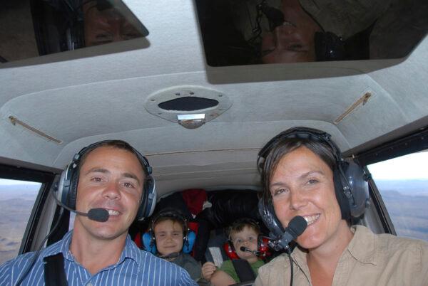 In this undated photo provided by FlyZolo, Zara Rutherford, as a young child, rear left, is a passenger on a flight piloted by her father Sam Rutherford. (FlyZolo via AP)