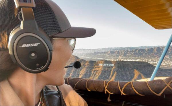 In this undated photo provided by FlyZolo, Zara Rutherford looks out from her cockpit at the Hollywood sign in Los Angeles. (FlyZolo via AP)