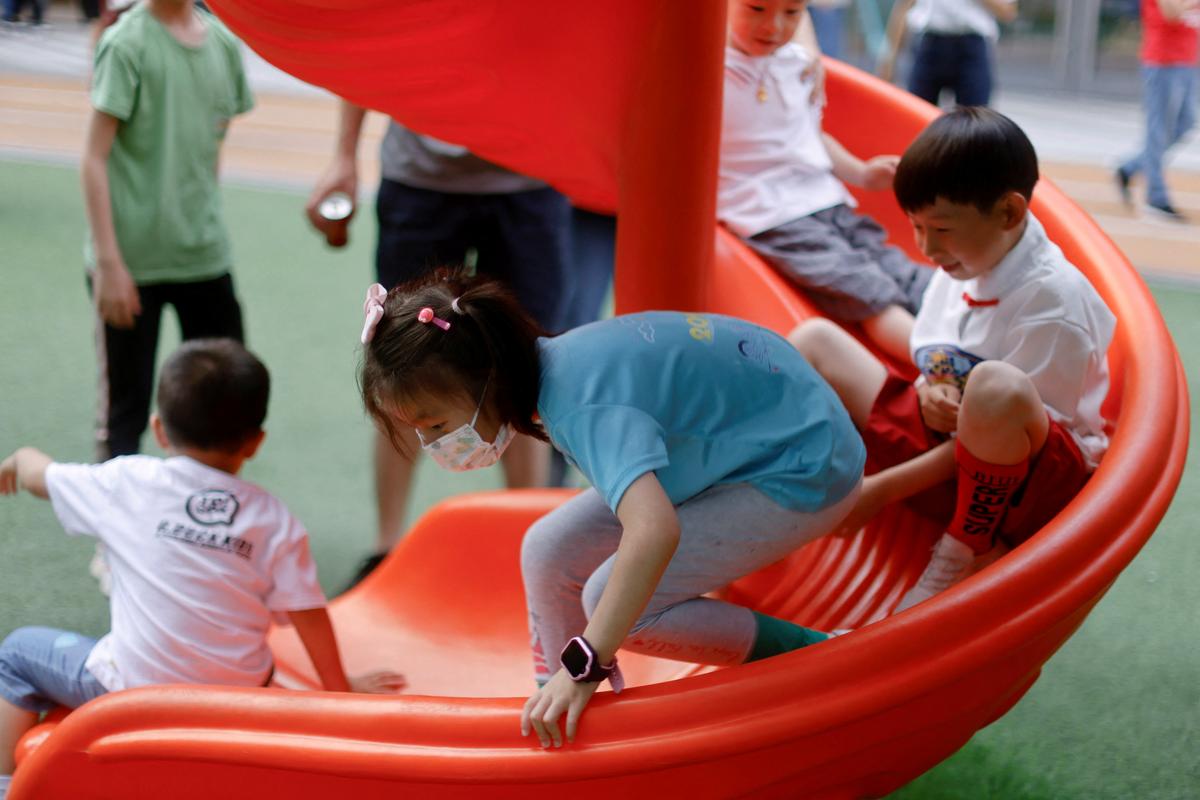 Children play at a playground inside a shopping complex in Shanghai on June 1, 2021. (Aly Song/Reuters)