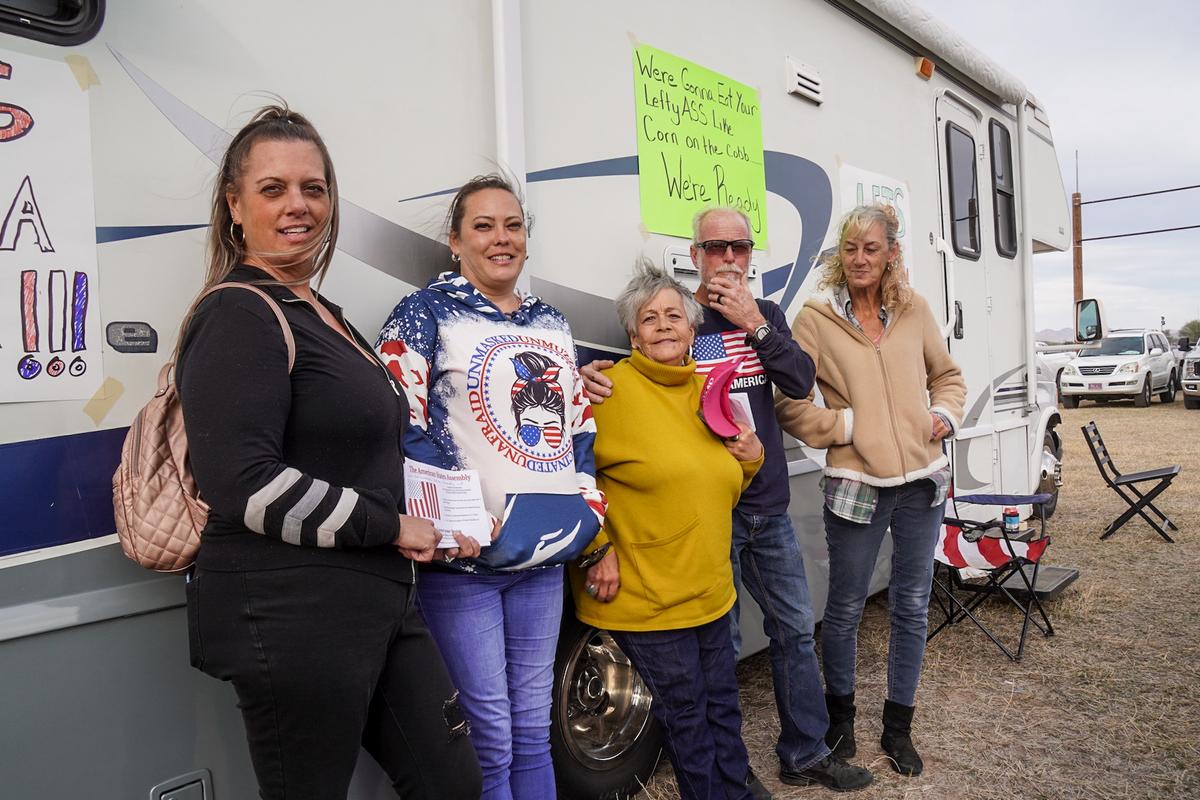 Tammy Mann, Christine Miller, Bobbi Bart, Tim Grubaugh, and Nancy Grubaugh of Tucson, Ariz., drove up in a camper van covered in anti-Joe Biden signs for the kick-off rally of President Donald Trump in Florence, Ariz., on Jan. 15, 2022. (Allan Stein/The Epoch Times)