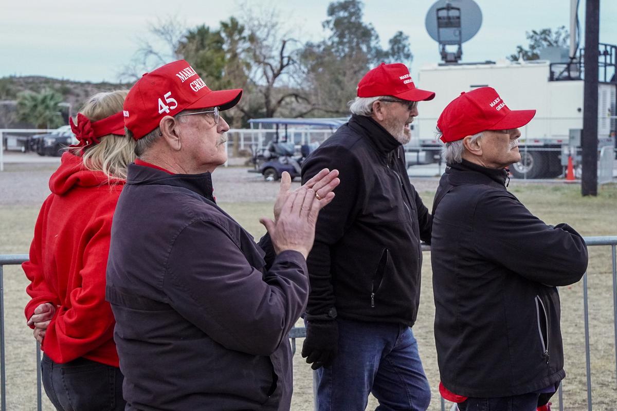 Donald Trump supporters wearing MAGA hats applaud a guest speaker at a 2022 "Save America" rally in Florence, Ariz., on Jan. 15, 2022. (Allan Stein/The Epoch Times)