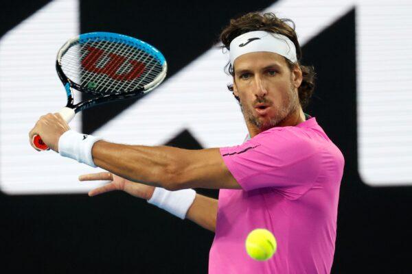 Feliciano Lopez of Spain plays a backhand return to John Millman of Australia during their first round match at the Australian Open tennis championships in Melbourne, Australia, on Jan. 17, 2022. (Hamish Blair/AP Photo)