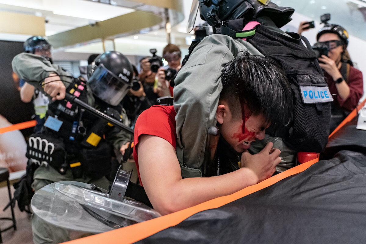 A man is detained by riot police during a demonstration in a shopping mall at Sheung Shui district in Hong Kong on Dec. 28, 2019. (Anthony Kwan/Getty Images)