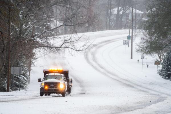 A Department of Transportation truck is driven down a snowy street in Greenville, S.C., on Jan. 16, 2022. (Sean Rayford/Getty Images)
