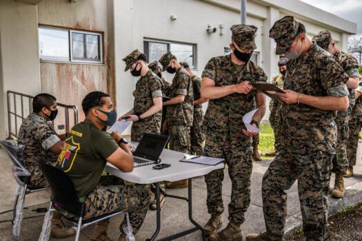 United States Marines register their details as they queue to receive the Moderna COVID-19 vaccine at Camp Hansen on April 28, 2021 in Kin, Japan. (Carl Court/Getty Images)