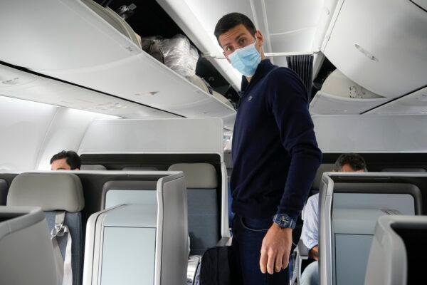 Novak Djokovic prepares to take his seat on a plane to Belgrade, in Dubai, United Arab Emirates, on Jan. 17, 2022. (Darko Bandic/AP Photo)