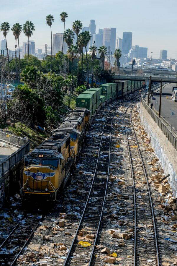 A train passes shredded boxes and packages at a section of the Union Pacific train tracks in downtown Los Angeles on Jan. 14, 2022. (Ringo H.W. Chiu/AP Photo)