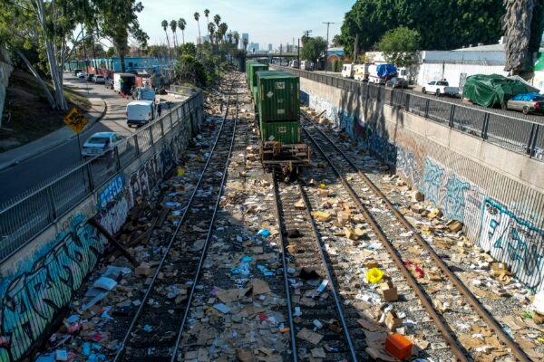 Shredded boxes, packages, and debris are strewn along at a section of the Union Pacific train tracks in downtown Los Angeles on Jan. 14, 2022. (Ringo H.W. Chiu/AP Photo)