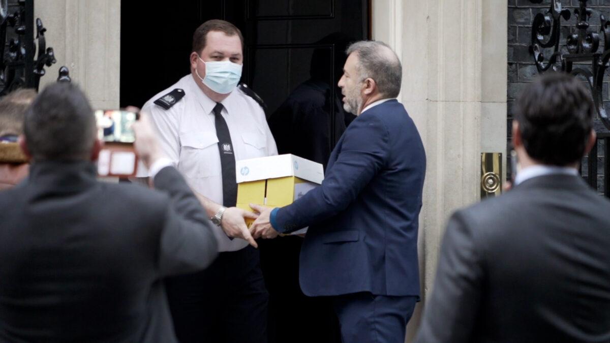 Alan Miller, who launched anti-restriction campaign Together, delivers petitions to Downing Street staff in London on Jan. 17, 2022. (Earl Rhodes/NTD)