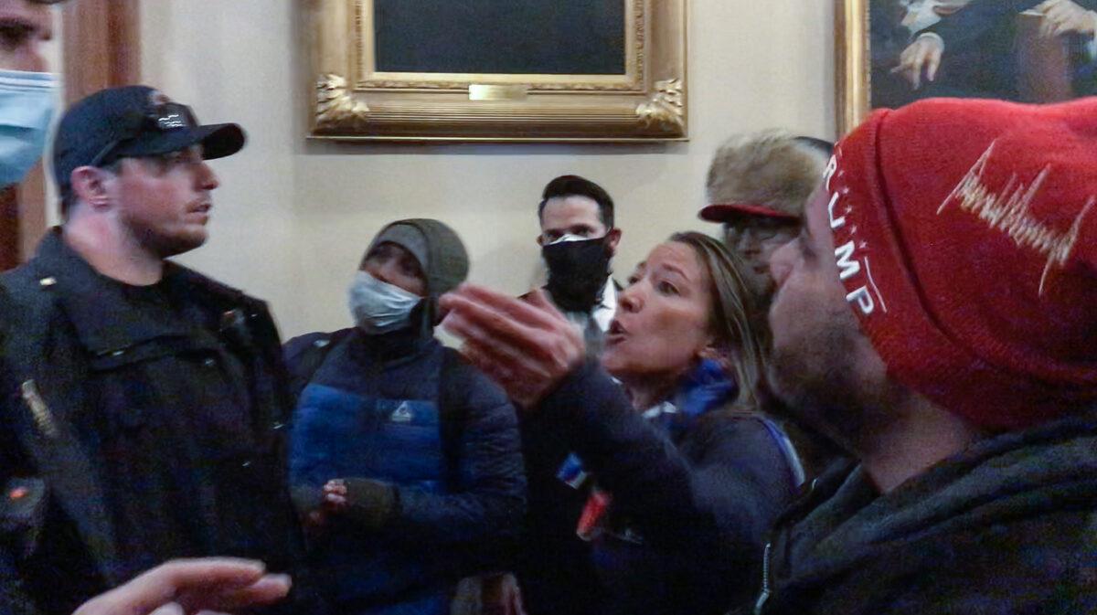Moments before being fatally shot, Ashli Babbitt confronts three police offers for not stopping the vandalism outside the U.S. House. (Video Still/Tayler Hansen)