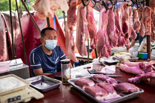 A vendor sells pork at an open market in Wuhan, China on May 31, 2021. (Getty Images)