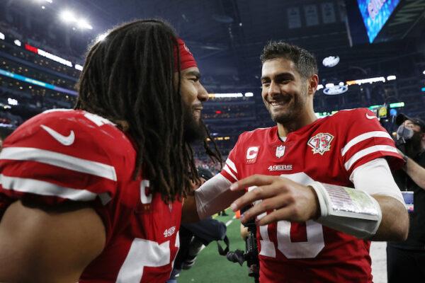 Fred Warner #54 and Jimmy Garoppolo #10 of the San Francisco 49ers walk off the field after defeating the Dallas Cowboys 23-17 in the NFC Wild Card Playoff game at AT&T Stadium, Texas, on January 16, 2022. (Tom Pennington/Getty Images)
