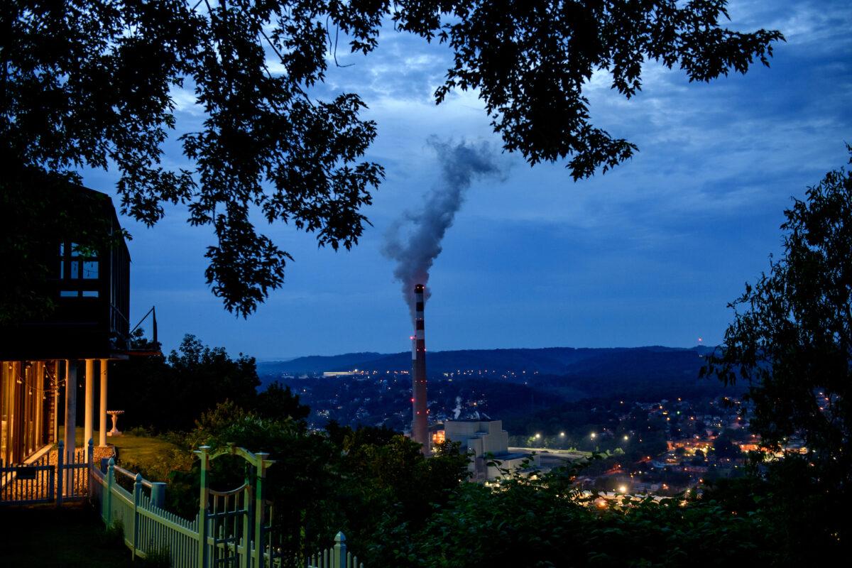 A backyard overlooks the valley to the GenOn Cheswick Power Station, which burns coal to produce 637 megawatts of electricity for the region, in Cheswick, Pa., on June 7, 2021. (Jeff Swensen/Getty Images)
