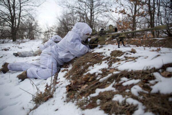 Snipers take part in military exercises at a firing ground of the Ukrainian armed forces in the Donetsk region, Ukraine, on Jan. 17, 2022. (Anna Kudriavtseva/Reuters)