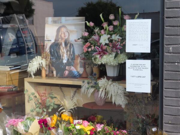 Flowers placed outside Croft House furniture store in memory of graduate student Brianna Kupfer are seen in Los Angeles, Calif., on Jan. 18, 2022. (Alice Sun/The Epoch Times)