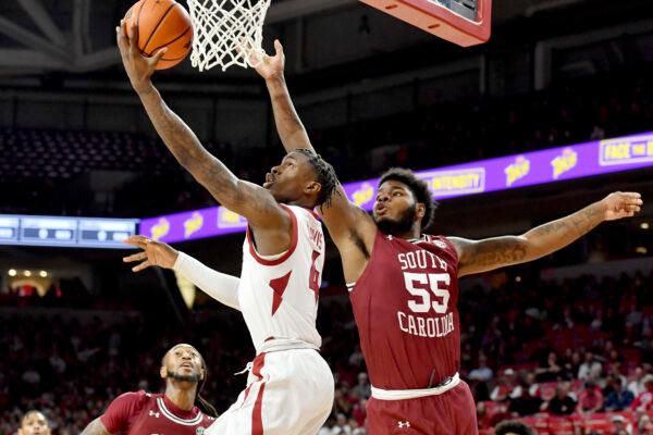Arkansas guard Davonte Davis (4) drives past South Carolina forward Ta'Quan Woodley (55) to score during the first half of an NCAA college basketball game in Fayetteville, Ark., on Jan. 18, 2022. (Michael Woods/AP Photo)