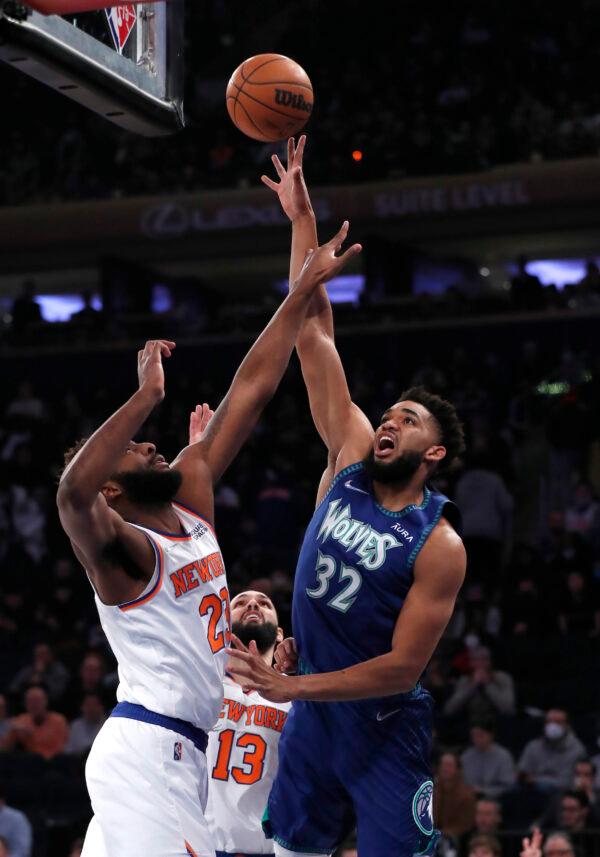 Minnesota Timberwolves center Karl-Anthony Towns (32) shoots over New York Knicks center Mitchell Robinson (23) during the first half of an NBA basketball game, in New York City, on Jan. 18, 2022. (Noah K. Murray/AP Photo)
