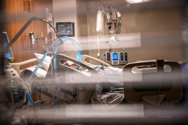  Breathing tubes hang next to a man with COVID-19 on a ventilator at a Stamford Hospital Intensive Care Unit in Stamford, Conn., on April 24, 2020. (John Moore/Getty Images)