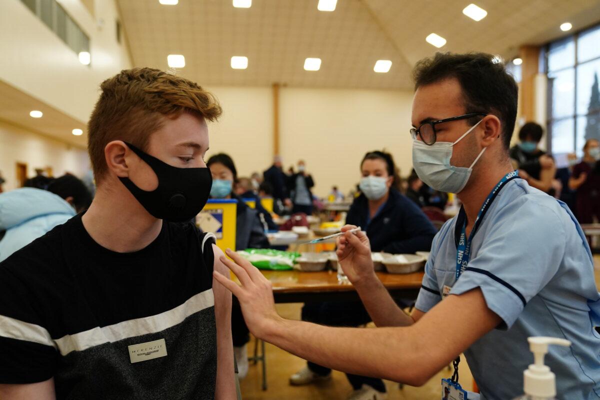 Owen Morrison, 15, receives a COVID-19 vaccine from student nurse Anthony McLaughlin at the Glasgow Central Mosque. (Jane Barlow/PA)