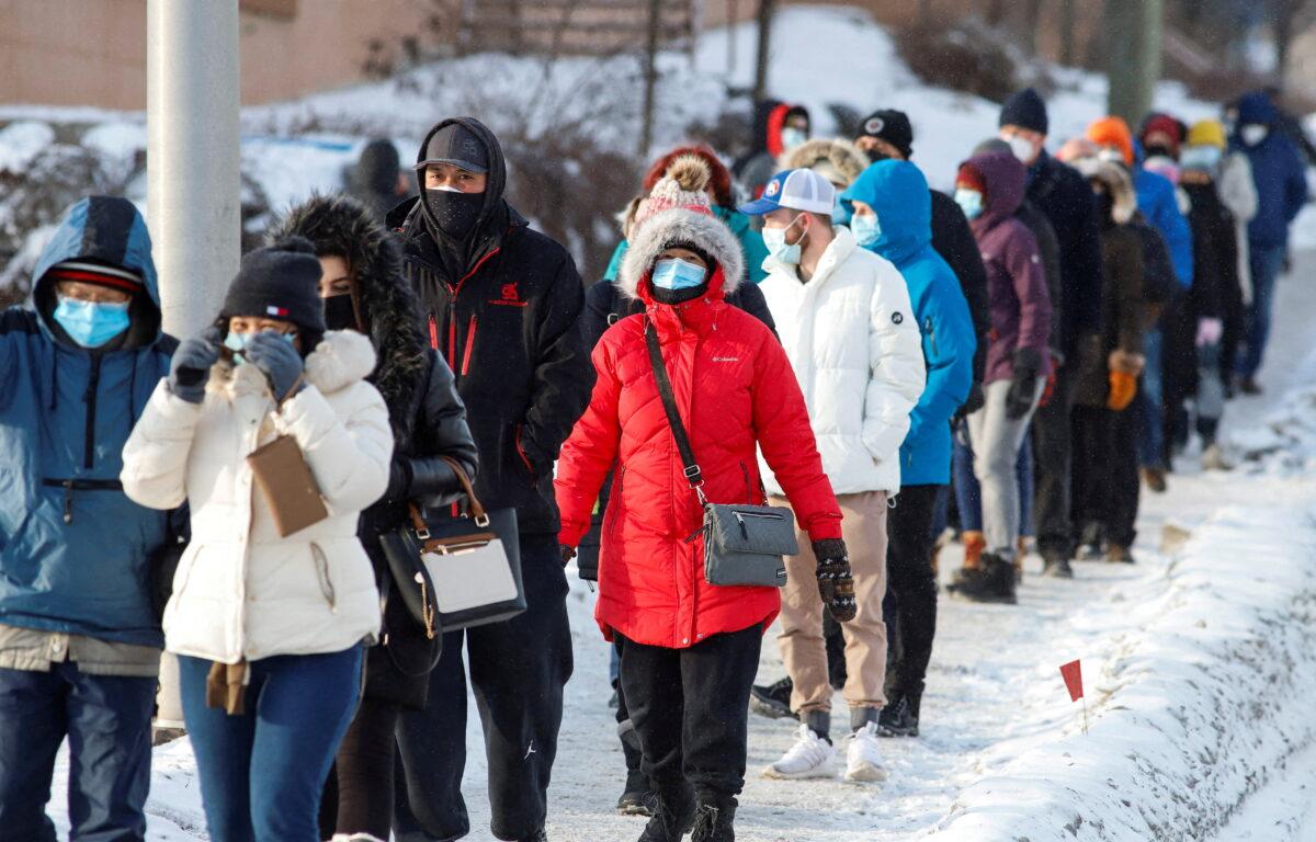 People queue to collect coronavirus disease (COVID-19) antigen test kits at the Hazeldean Mall in Ottawa, Ontario, Canada on January 7, 2022. (Patrick Doyle/Reuters)