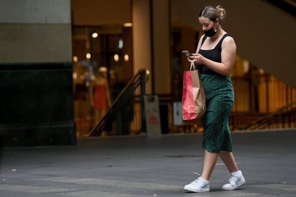 A shopper holds a retail bag in Pitt St Mall, Sydney, Australia, on Jan. 11, 2022. (AAP Image/Bianca De Marchi)