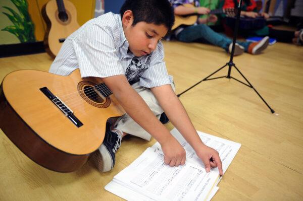 Eric, 8, warms up for the “Progress Recital for Parents” at Musical Mentors in 2008. “He stayed with the program for three years and overcame many difficulties,” said Duff Rowden. “We were very proud of him.” (Courtesy of Duff Rowden)
