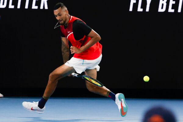 Nick Kyrgios of Australia plays a shot back between his legs during his second round match against Daniil Medvedev of Russia at the Australian Open tennis championships in Melbourne, Australia, on Jan. 20, 2022. (Hamish Blair/AP Photo)