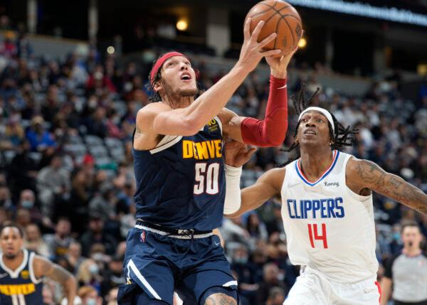 Denver Nuggets forward Aaron Gordon, front, drives to the rim past Los Angeles Clippers guard Terance Mann in the first half of an NBA basketball game in Denver, on Jan. 19, 2022. (David Zalubowski/AP Photo)