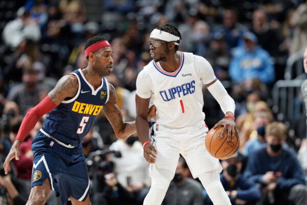 Los Angeles Clippers guard Reggie Jackson, right, looks to pass the ball as Denver Nuggets forward Will Barton defends in the first half of an NBA basketball game in Denver on Jan. 19, 2022. (David Zalubowski/AP Photo)