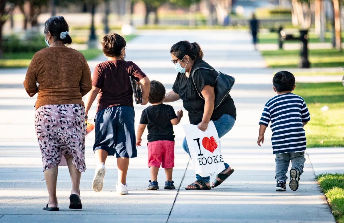 A family walks together in Westminster, Calif., on Sept. 22, 2020. (John Fredricks/The Epoch Times)