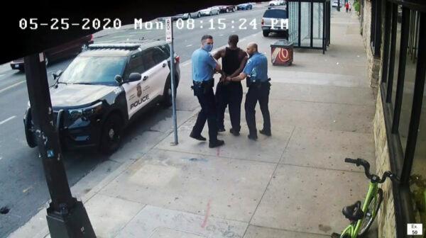 This image from a video shows Minneapolis police officers Thomas Lane (L), and J. Alexander Kueng (R), escorting George Floyd (C), to a police vehicle outside Cup Foods in Minneapolis on May 25, 2020. (Court TV via AP)