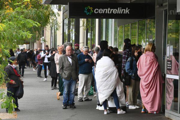 Hundreds of people queue outside an Australian government welfare centre, Centrelink, in Melbourne on March 23, 2020, as jobless Australians flooded unemployment offices around the country. (William West/AFP via Getty Images)