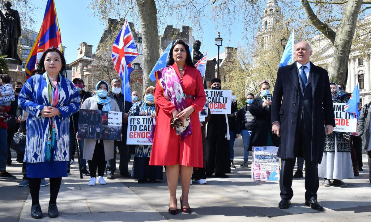 British Conservative Party MPs Nusrat Ghani (C), Sir Iain Duncan Smith (R), and UK Director of the World Uyghur Congress Rahima Mahmut at a demonstration calling on the UK Parliament to vote to recognize alleged persecution of China's Uyghurs as genocide and crimes against humanity in London on April 22, 2021. (Justin Tallis/AFP via Getty Images)