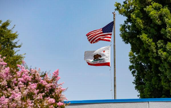 Flags fly at the Hewes Middle School in Tustin, Calif., on Aug. 12, 2021. (John Fredricks/The Epoch Times)