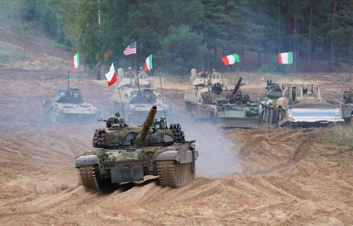 Poland, Italy, Canada, and United States military vehicles and tanks roll during the NATO military exercises ''Namejs 2021'' at a training ground in Kadaga, Latvia, on Sept. 13, 2021. (Roman Koksarov/AP)
