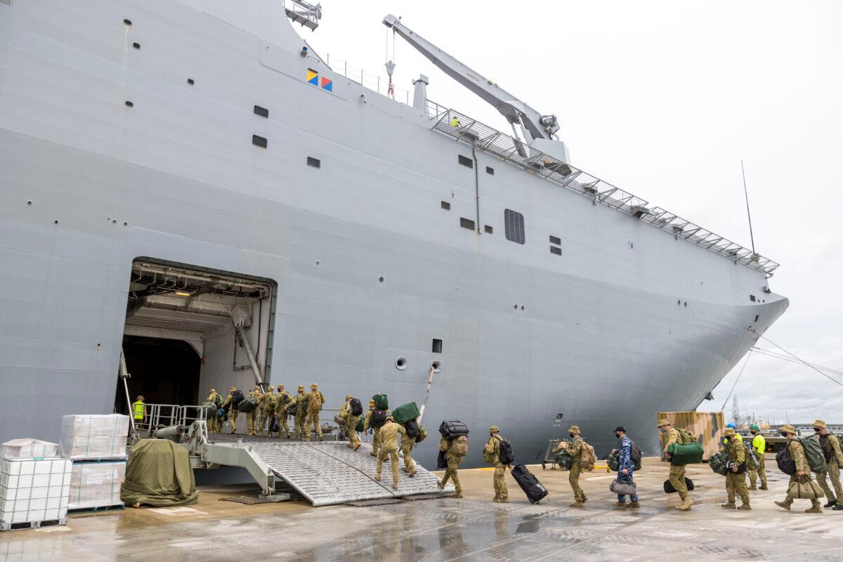 Members of the Australian Defence Force board the HMAS Adelaide as they prepare to depart for an aid mission at the Port of Brisbane in Nuku'alofa, Tonga, on Jan. 20, 2022. (CPL Robert Whitmore/Australian Defence Force via Getty Images)