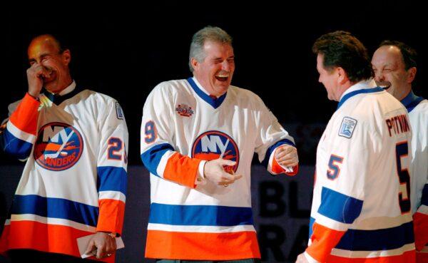 Clark Gillies (2nd L) greets Denis Potvin (2nd R) as Bryan Trottier (R) and Bobby Nystrom (L) get a chuckle out of the encounter during introductions for "The Core of the Four" New York Islanders teams that won consecutive Stanley Cups from 1979 to 1982, at Nassau Coliseum in Uniondale, New York, on March 2, 2008. (Kathy Willens/AP Photo)