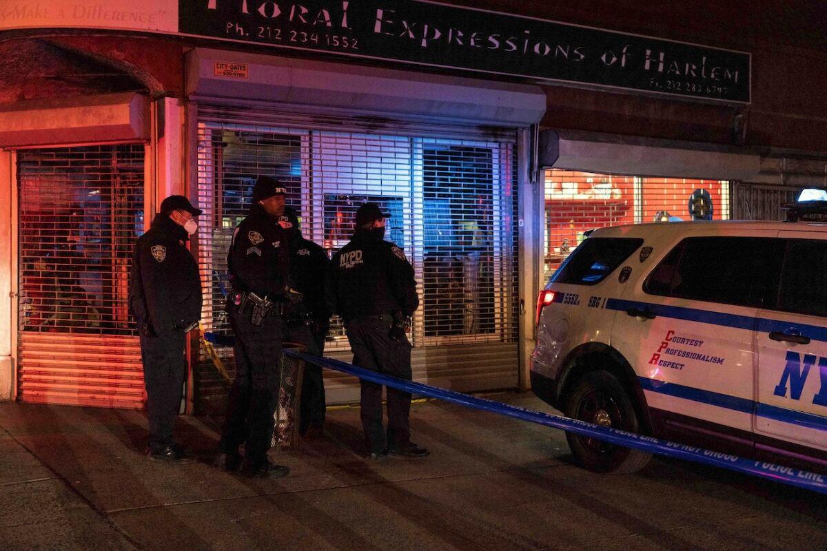 NYPD officers are seen at the scene of the shooting in Harlem, in N.Y., on Jan. 21, 2022. (Yuki Iwamura/AP Photo)