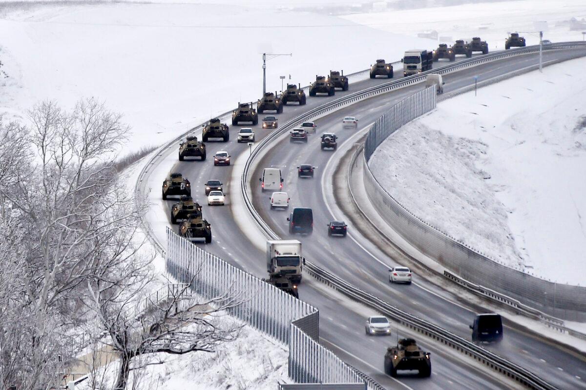 A convoy of Russian armored vehicles moves along a highway in Crimea, on Jan. 18, 2022. (AP Photo)