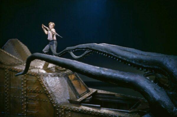 Ned Land (Kirk Douglas) confronts a sea monster from atop the Nautilus. (Walt Disney Productions)