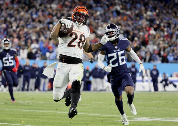 Running back Joe Mixon #28 of the Cincinnati Bengals rushes for a third quarter touchdown in front of cornerback Kristian Fulton #26 of the Tennessee Titans during the AFC Divisional Playoff game at Nissan Stadium, in Nashville, on Jan. 22, 2022. (Andy Lyons/Getty Images)