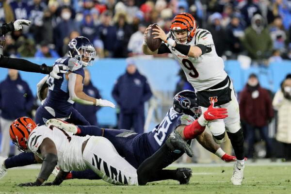 Defensive end Jeffery Simmons #98 of the Tennessee Titans tackles quarterback Joe Burrow #9 of the Cincinnati Bengals in the third quarter of the AFC Divisional Playoff game at Nissan Stadium, in Nashville, on Jan. 22, 2022. (Andy Lyons/Getty Images)