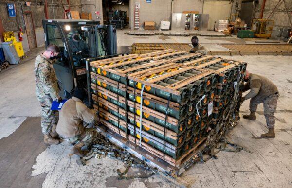 Airmen and civilians from the 436th Aerial Port Squadron palletize ammunition, weapons, and other equipment bound for Ukraine at Dover Air Force Base in Delaware, on Jan. 21, 2022. (U.S. Air Force/Mauricio Campino/Handout via Reuters)