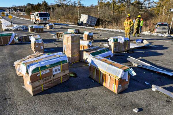 Crates holding live monkeys are scattered across the westbound lanes of State Route 54 at the junction with Interstate 80 near Danville, Pa., on Jan. 21, 2022, after a pickup pulling a trailer carrying the monkeys was hit by a dump truck. (Jimmy May/Bloomsburg Press Enterprise via AP)