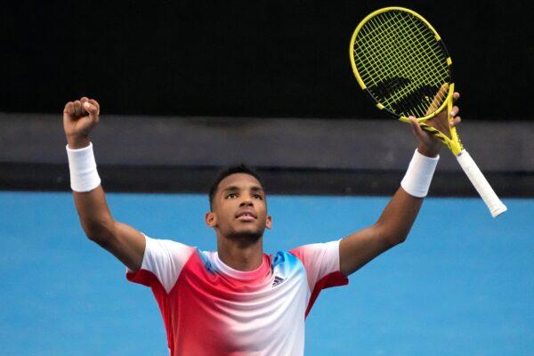 Felix Auger-Aliassime of Canada celebrates after defeating Marin Cilic of Croatia in their fourth round match at the Australian Open tennis championships in Melbourne, Australia, on Jan. 24, 2022. (Simon Baker/ AP Photo)