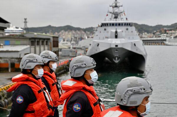 Taiwan military personnel stand next to the domestically produced corvette class vessel Tuo Chiang during a drill at the northern city of Keelung, Taiwan, on Jan. 7, 2022. (Sam Yeh/AFP via Getty Images)