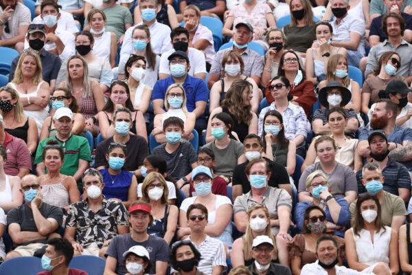 Spectators watch the fourth round singles match between Ashleigh Barty of Australia and Amanda Anisimova of United States during day seven of the 2022 Australian Open in Melbourne, Australia, on Jan. 23, 2022. (Cameron Spencer/Getty Images)